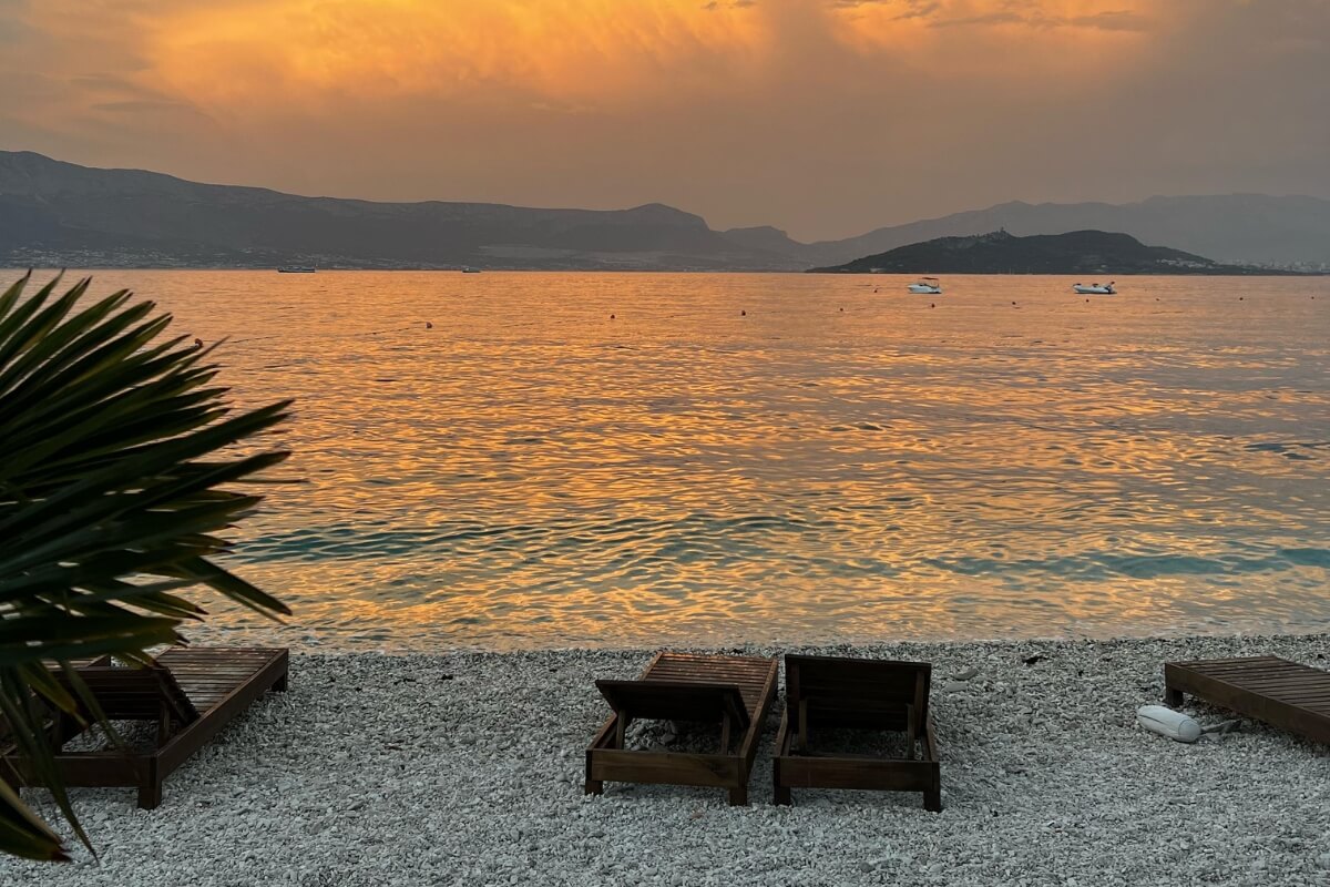 Sunset over the Adriatic Sea near Kaštela with beach and mountain view